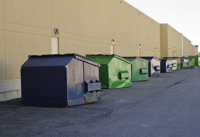 a construction worker disposing of debris into a dumpster in Cheshire